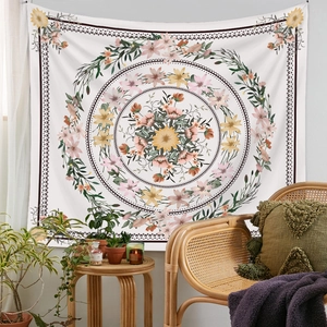 Bohemian floral mandala tapestry hanging in cozy room with rattan chair and pillows