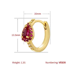 Golden huggie hoop earrings featuring pear-cut red gemstone and crystal maple leaf detail