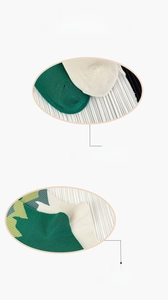 Detailed close-up of seamless toe and reinforced heel on green knitted socks