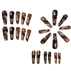 Detail of long ballerina fake nails with brown marble patterns and gold line accents