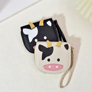 Cute cartoon cow-shaped PU wallets in black and white with 3D horns and wrist straps
