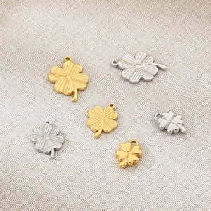 Set of six stainless steel four-leaf clover pendants in 18K gold and silver finishes