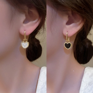 Elegant gold heart earrings with black and white enamel finish and vintage textured edges