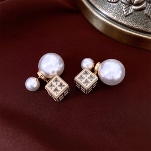 Detailed view of French-style double-sided pearl earrings with square zircon charms