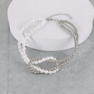Detail of beaded necklace featuring white faux pearls and silver metal beads with lobster clasp