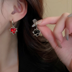 Thorn-wrapped heart drop earrings with red and black gems in silver metal finish