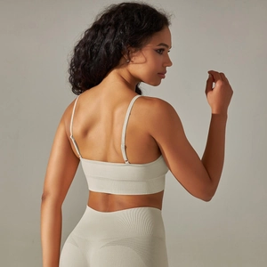 Detailed view of sage green ribbed seamless sports bra with cross back and breathable mesh