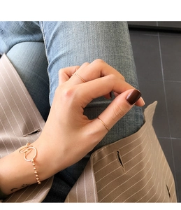 Minimalist S925 sterling silver ultra-thin gold rings and beaded bracelet on a model