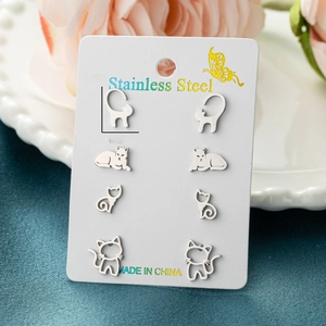 Set of 4 pairs stainless steel cat stud earrings displayed on white card packaging