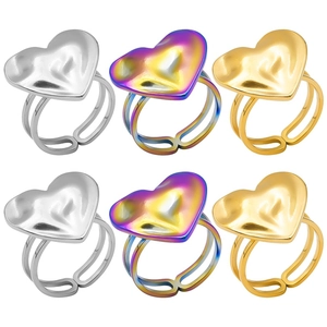 Detailed view of adjustable heart rings in silver, gold, and rainbow metallic finishes