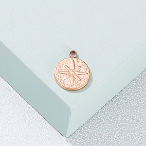 Polished rose gold round stainless steel pendant with compass star relief carving