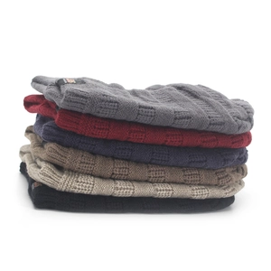Stack of six knitted beanies in diverse colors featuring square textured weave patterns