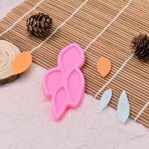 Leaf shaped silicone mold for chocolate and fondant cake decorating on bamboo mat