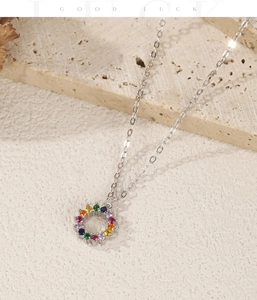 Macro shot of S925 sterling silver necklace featuring a circular multi-color gemstone pendant