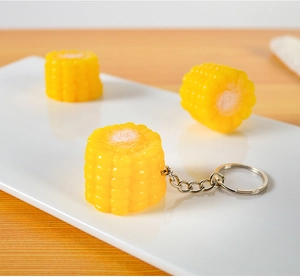 Realistic artificial corn keychain detail with textured kernels and silver metal ring
