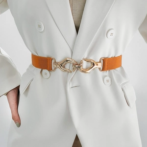 Women fashion elastic waist belt with golden wavy alloy buckle on white suit