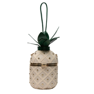 Detail of pineapple-shaped cream white PU leather crossbody bag with golden rivet studs