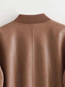 Detail view of the brown leather bomber jacket collar with ribbed knit neck and stitching