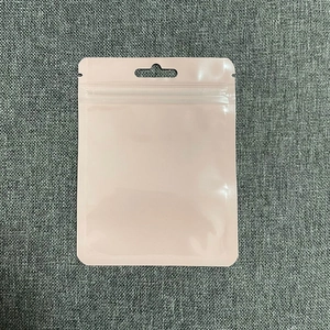 Pink self-sealing plastic pouch with hanging hole for jewelry and accessories