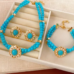 Vintage style jewelry set with blue beaded necklace bracelet and rhinestone earrings