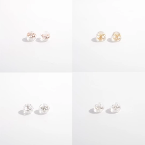 Detail view of four pairs of silicone earring backs in gold, silver, and rose gold finishes