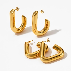 Detailed macro view of gold geometric U-shaped earrings with mirror-polished metal finish