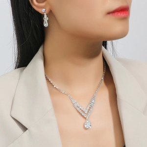 Elegant zircon necklace and earrings bridal set with pear-shaped drops on model