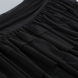 Detail shot of black mesh fabric showing intricate layered pleats and fine texture