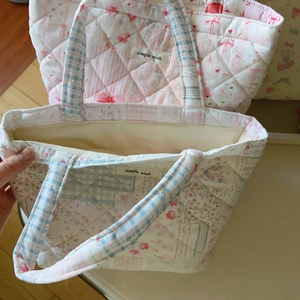 Close-up of quilted floral tote bag with patchwork patterns and internal lining
