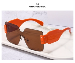 Detail of orange wide temples and tea lenses on fashion oversized sunglasses