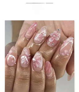 Detail of 3D embossed flowers, pearls, and rhinestones on long almond press-on nails