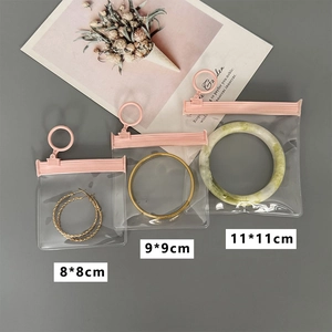 Three sizes of thickened transparent jewelry bags with pink zippers and hanging loops