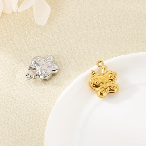 Stereo hollow butterfly pendants in gold and silver finish on a textured background