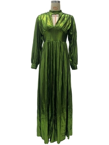 Detail of the emerald green metallic pleated dress with high waist and halter V-neckline