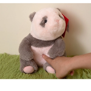 Close-up of soft pink and grey panda plush toy showing fluffy long-pile texture and tag