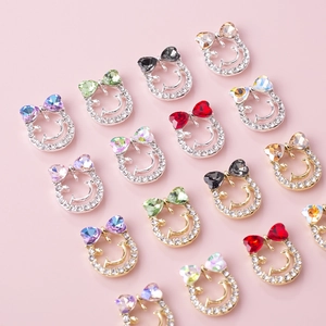 Bowtie smiley face nail art charms with colorful rhinestones in gold and silver settings