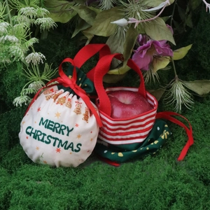 Close-up of fabric Christmas gift bags with drawstrings and gingerbread man patterns