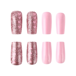 Close-up of pink glitter nails with heart patterns and glossy square press-on nails