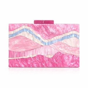 Close-up of pink acrylic evening clutch with colorful wave patterns and buckle