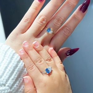 Toi et Moi gold-plated ring with blue and white zircons shown on mother and daughter