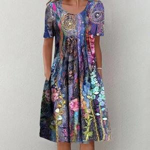 Detail view of colorful floral print dress featuring a round neck and side pockets