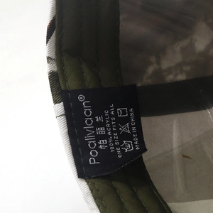Detail view of the baseball cap's inner label showing 100% acrylic material and size info