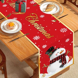 Festive Christmas table runner featuring a snowman and snowflakes on a wooden dining table