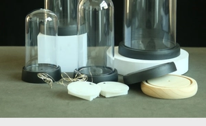 DIY preserved flower kit showing clear acrylic domes, black bases and LED string lights