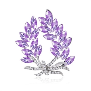 Detailed view of leaf wreath brooch with purple marquise rhinestones and silver metal base