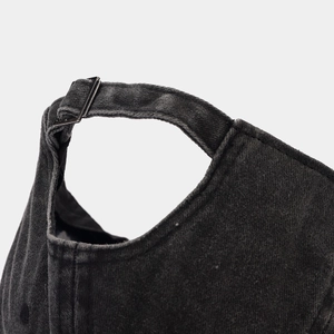 Detail of adjustable metal buckle on washed denim baseball cap with premium stitching