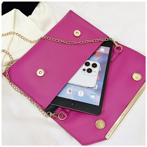 Internal capacity of the pink envelope clutch showing space for an iPad and iPhone