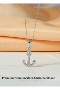 Macro shot of silver titanium steel anchor pendant with zircon inlay and thin O-chain