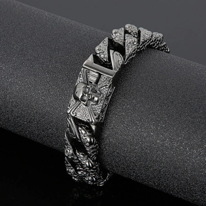 Detailed view of punk skull charm on a gunmetal titanium steel Cuban link bracelet