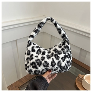Detail shot of plush black and white leopard print tote bag texture and fluffy material
